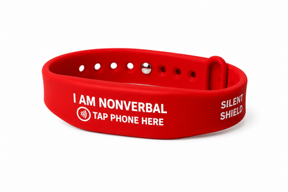 A red silicone silent alarm wristband with white printed text reading 'I AM NONVERBAL', 'TAP PHONE HERE', and 'SILENT SHIELD' on a white background.