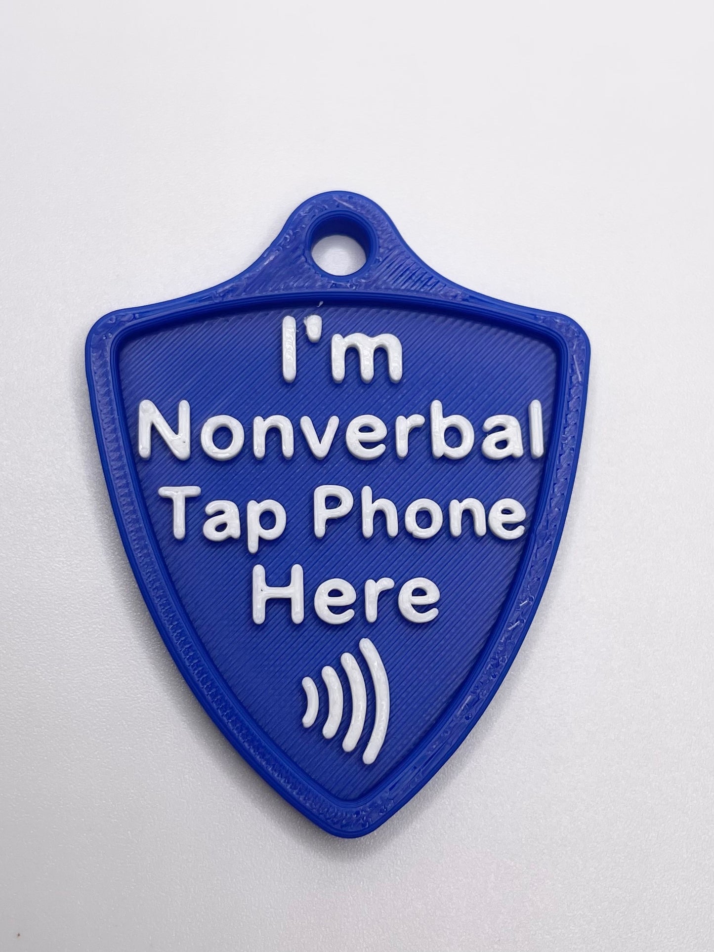 Blue plastic tag with text 'I'm Nonverbal Tap Phone Here' on a white background